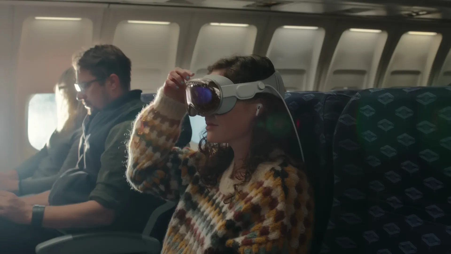 A totally normal human wearing Apple Vision Pro on a plane.